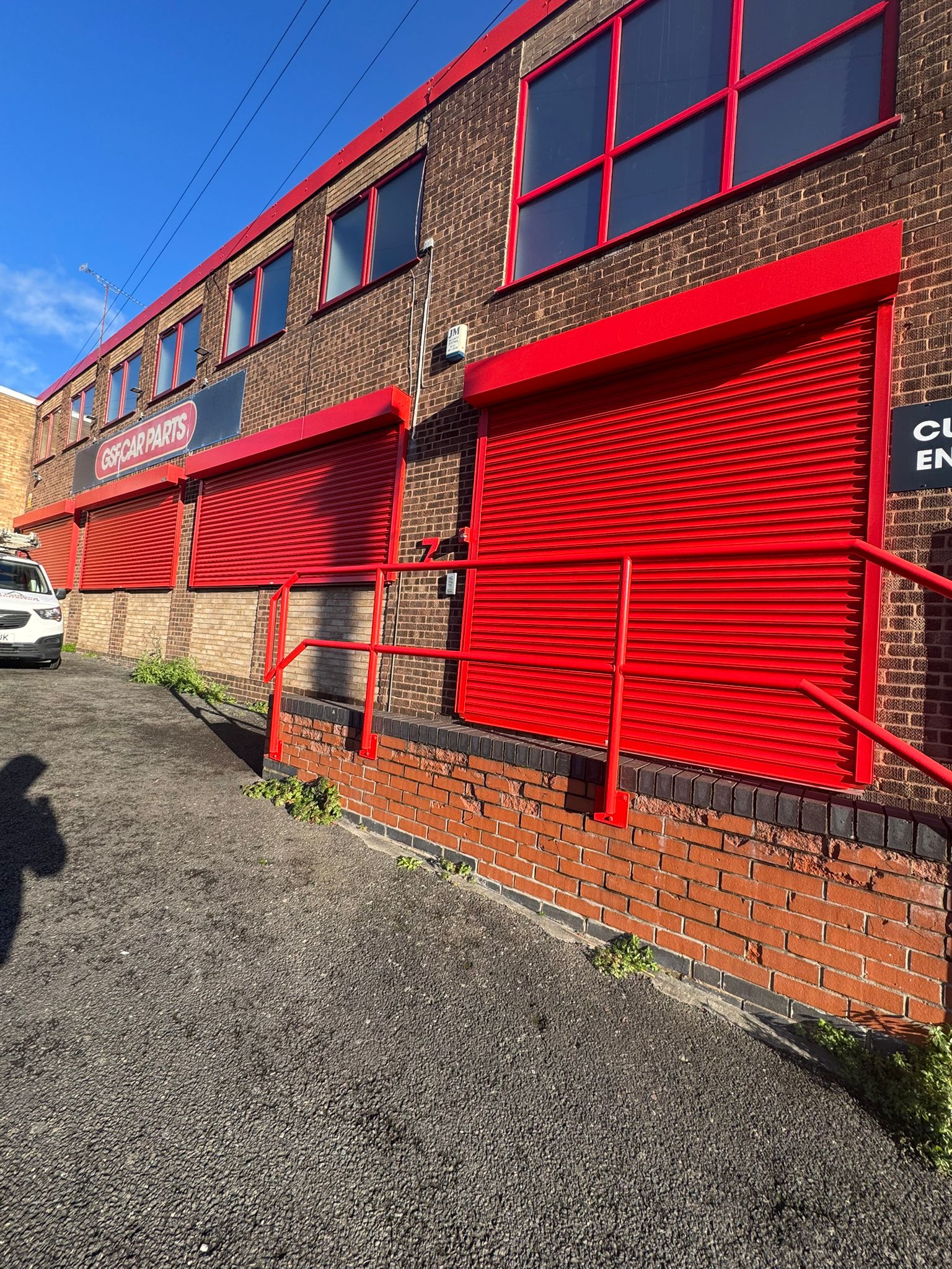 GSF Car Parts warehouse with freshly coated red roller shutters