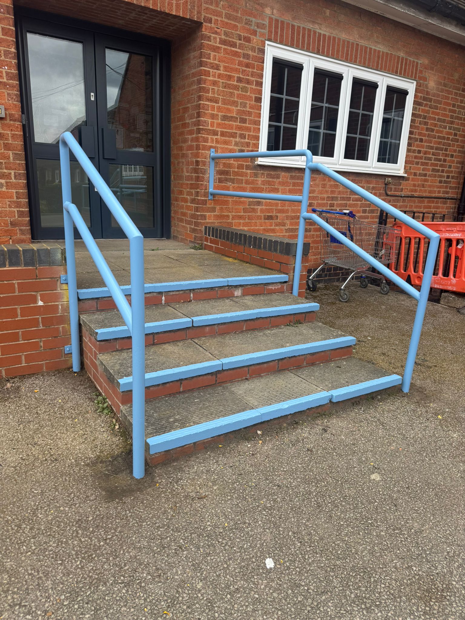 School exterior ramp and handrails with fresh blue protective coating in Blaby
