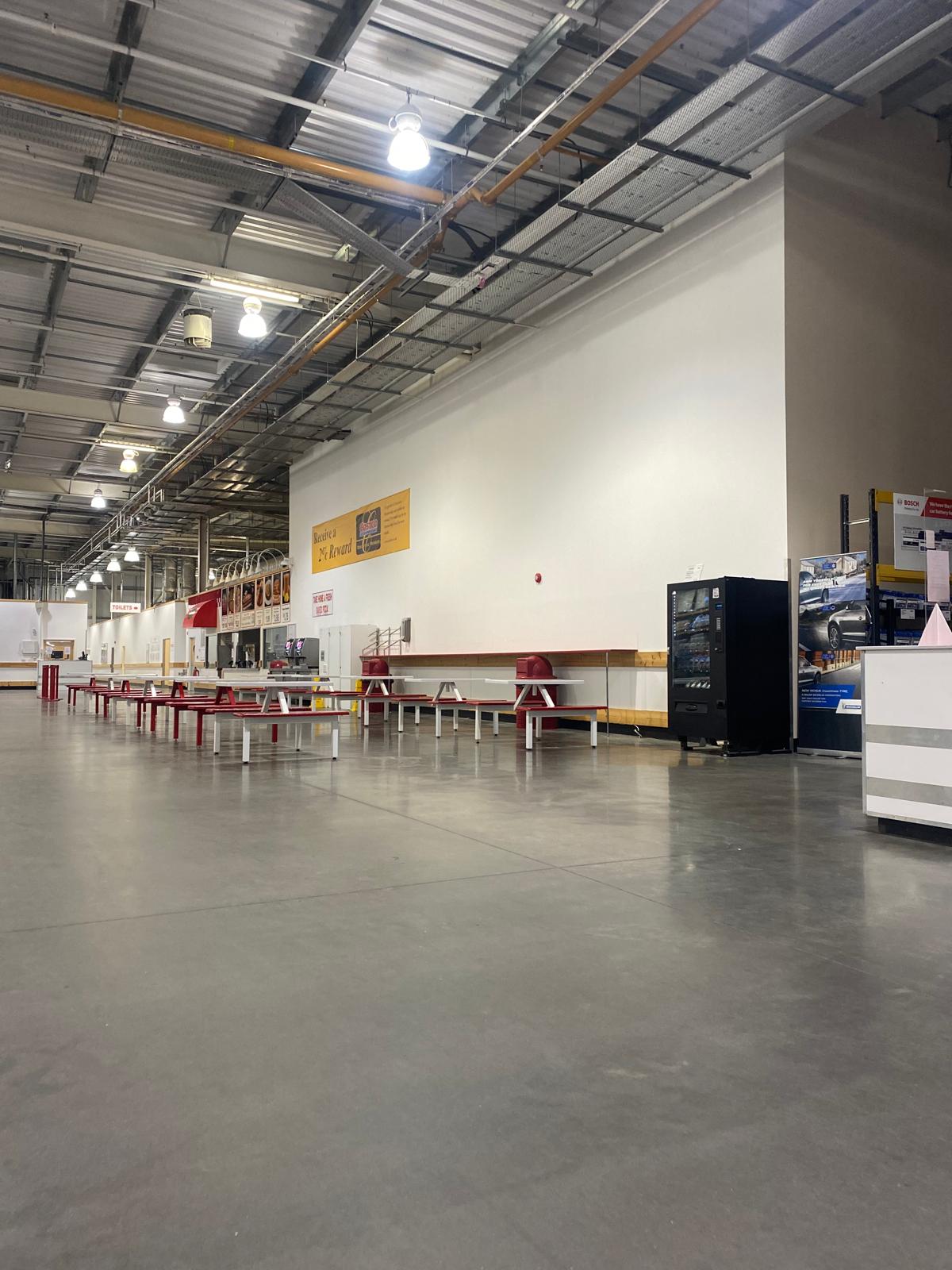 Large retail food court with repainted walls and ceilings