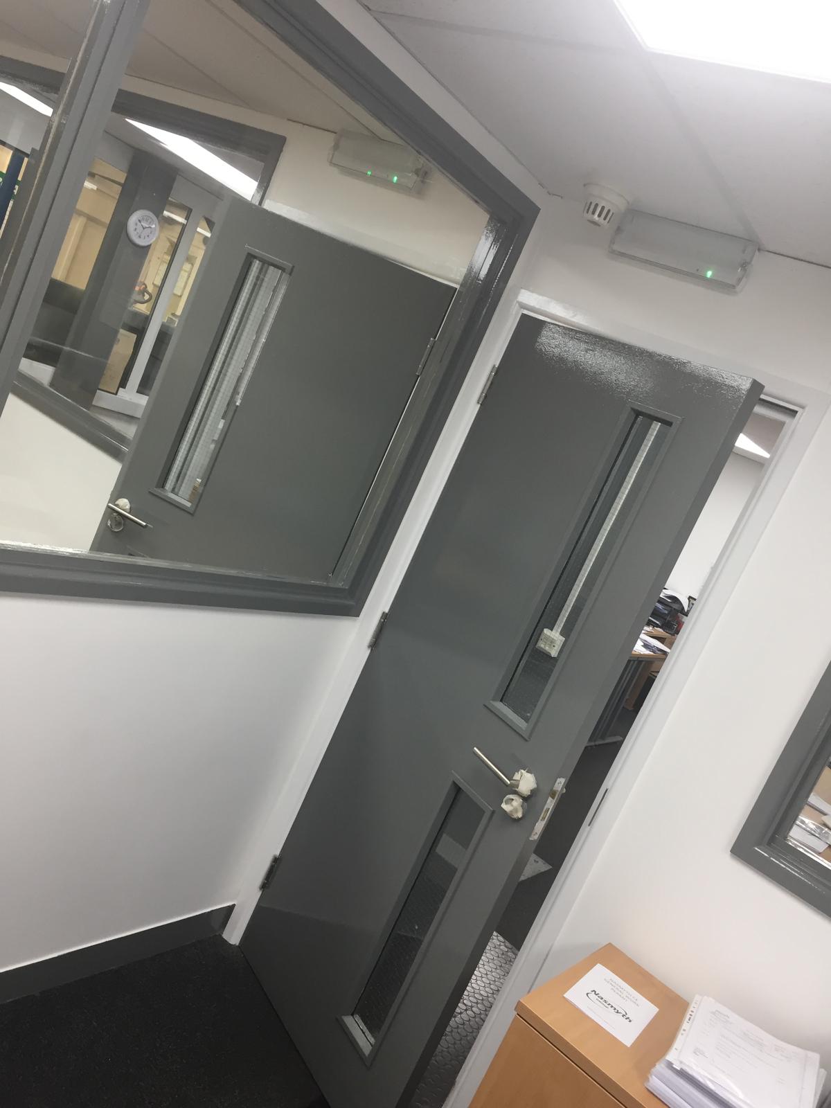 Commercial corridor with maintained fire doors and walls