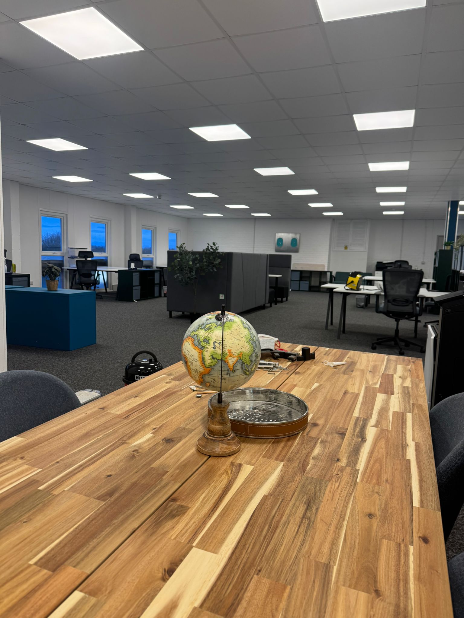 Open-plan office with neutral walls and sharp trim lines