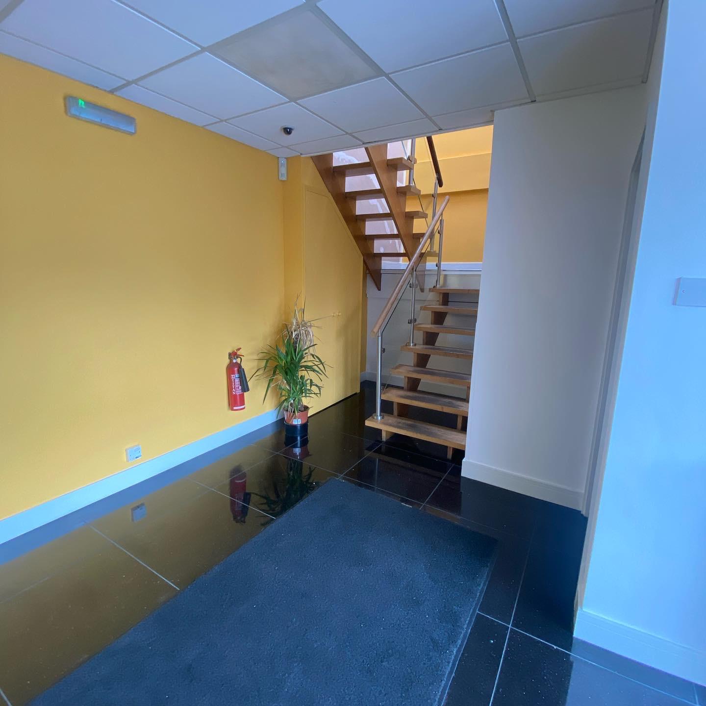 Qualvis stair hall with bold yellow accents and crisp white paint