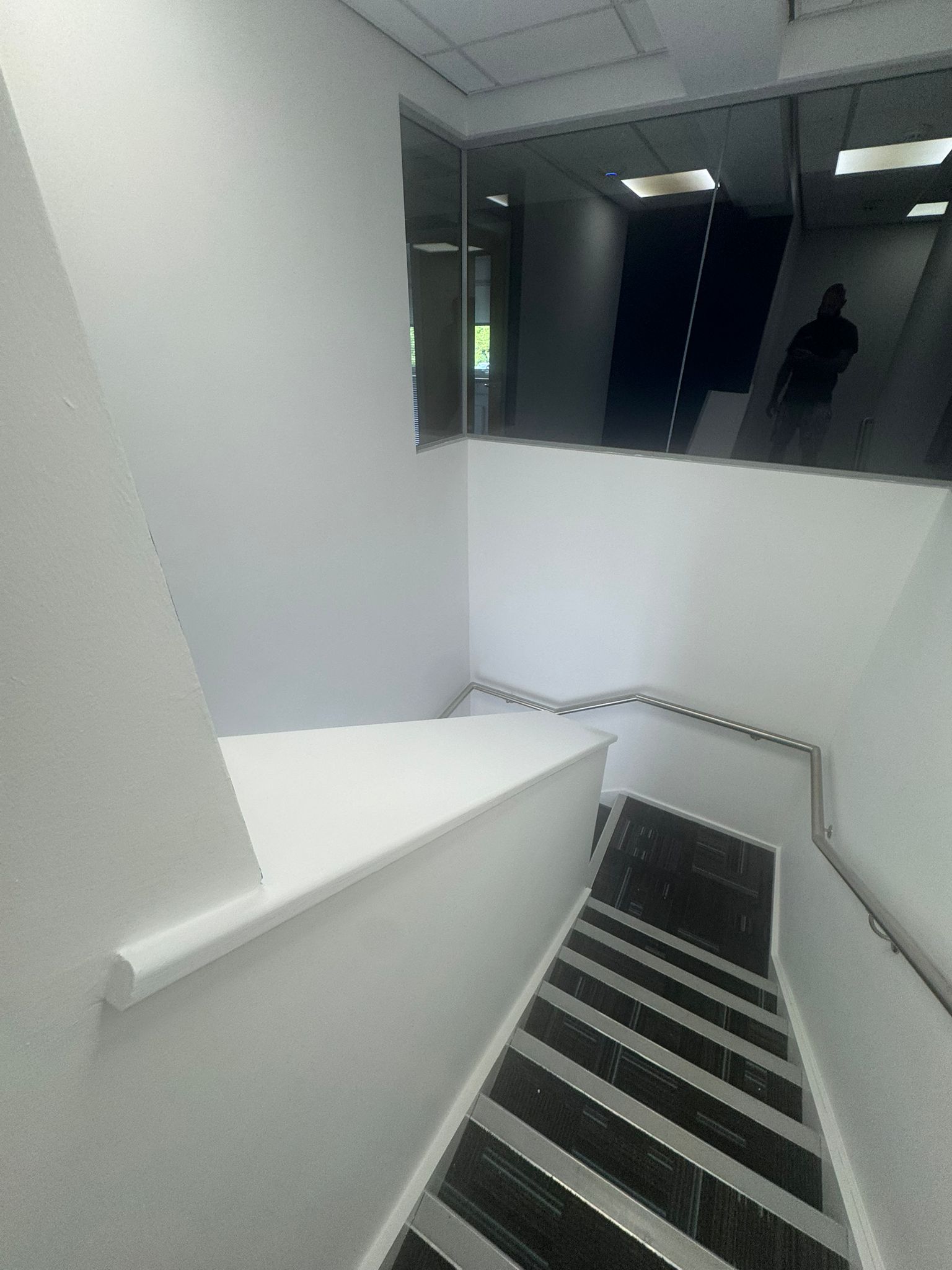 Freshly decorated commercial stairwell with white walls
