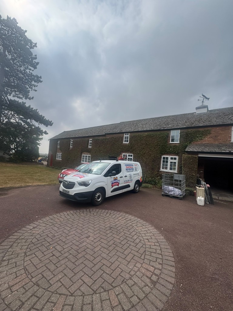 A.S Painting Contractors van parked at the ivy-clad farmhouse during the exterior re-paint project