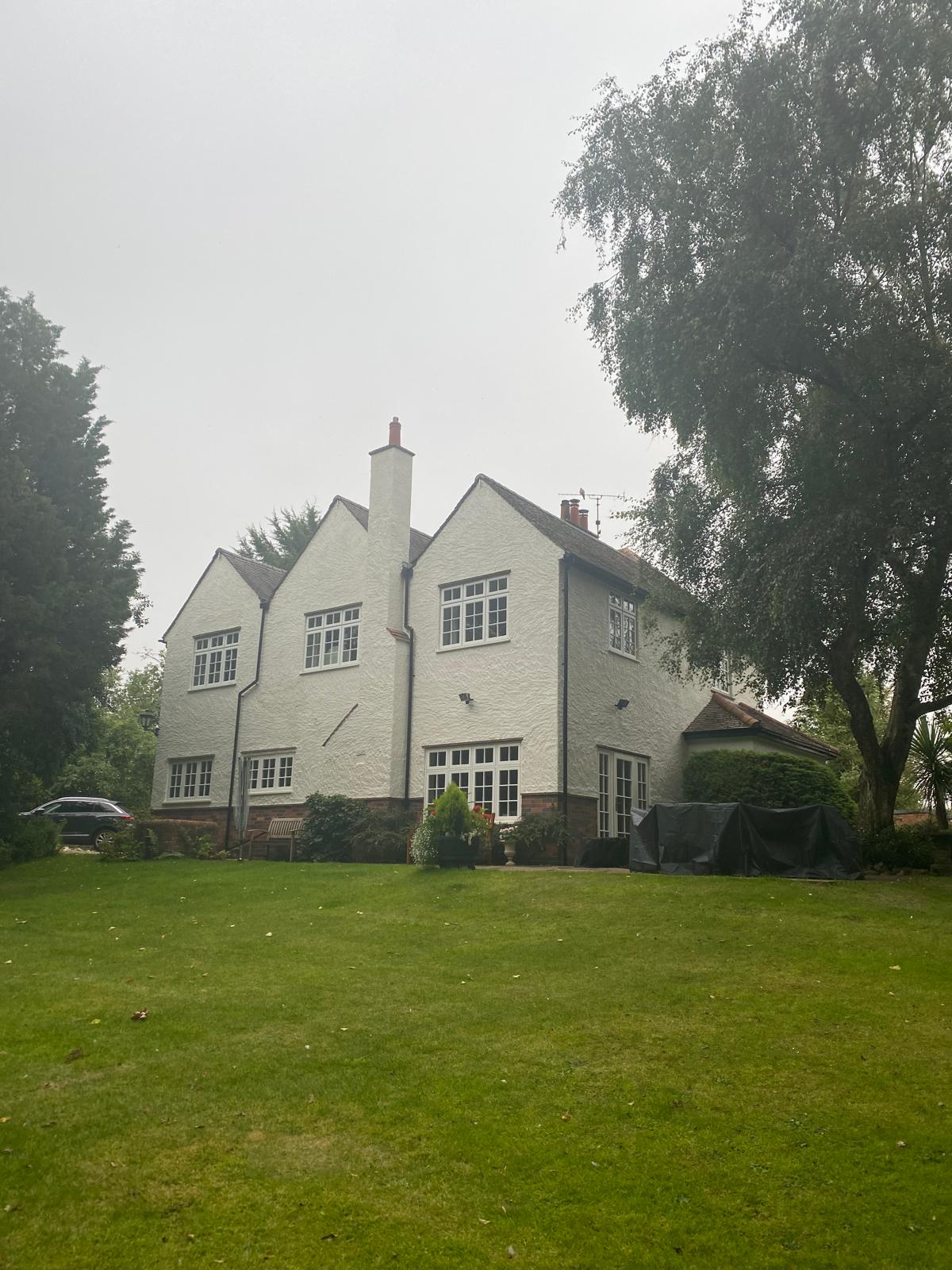 Period home rear elevation with crisp white render and painted woodwork