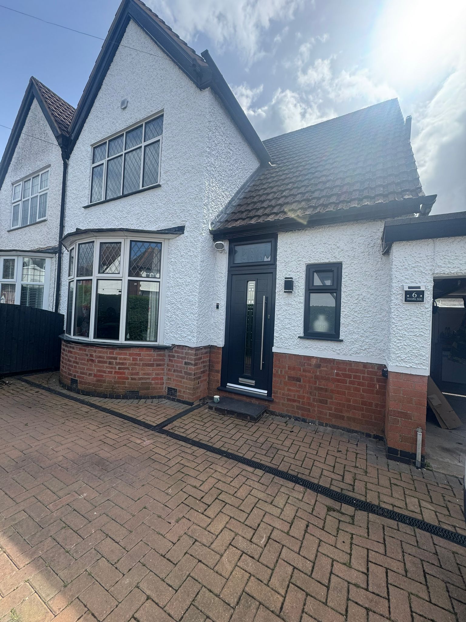 White pebbledash frontage with freshly painted finish