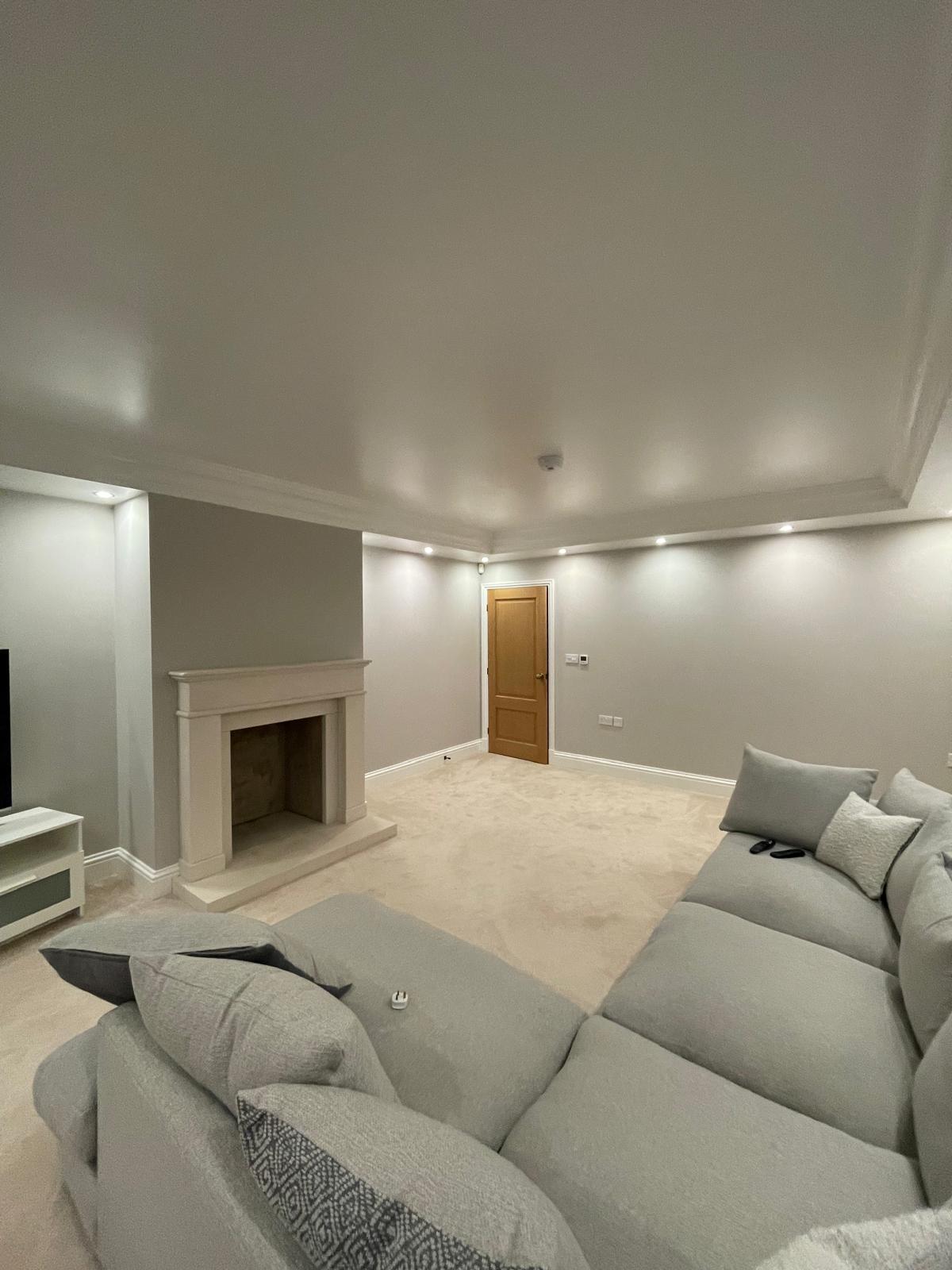 Cosy cinema snug with fireplace and freshly decorated walls