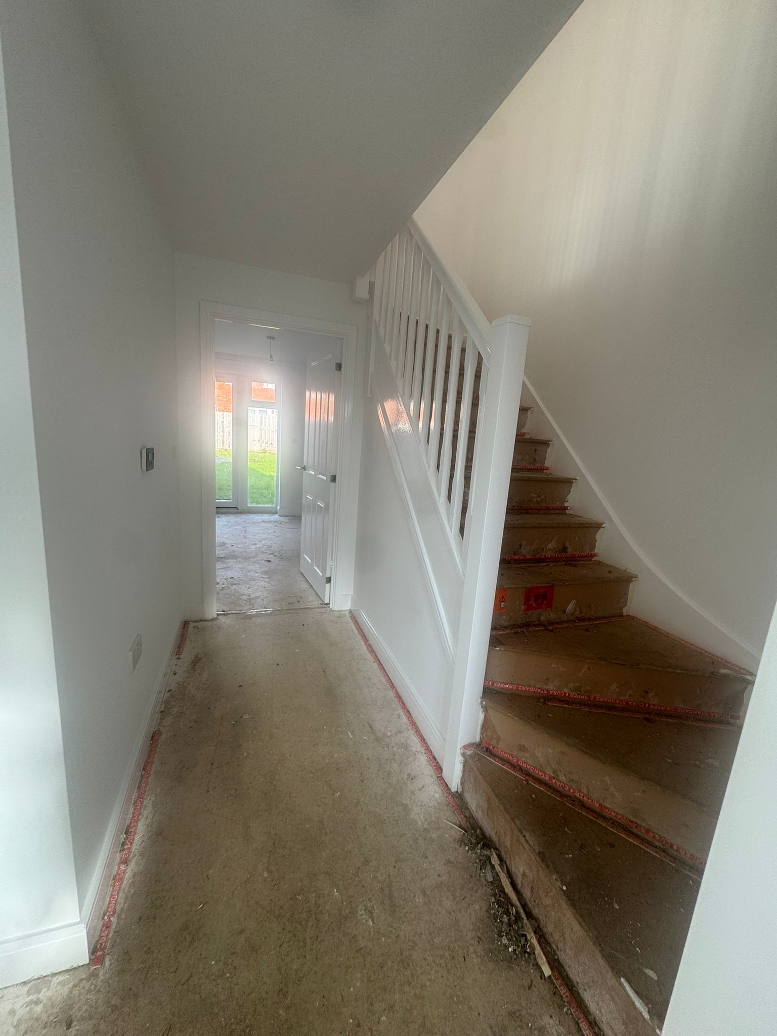 Hallway and staircase with fresh paint and crisp woodwork
