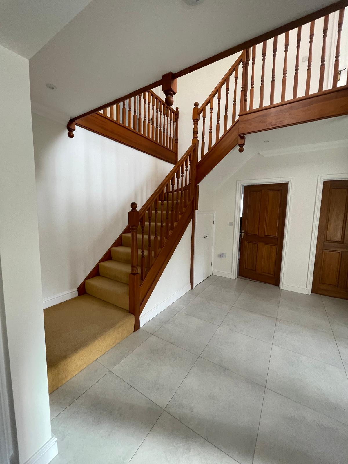 Oak staircase and hallway with freshly painted walls in Blaby