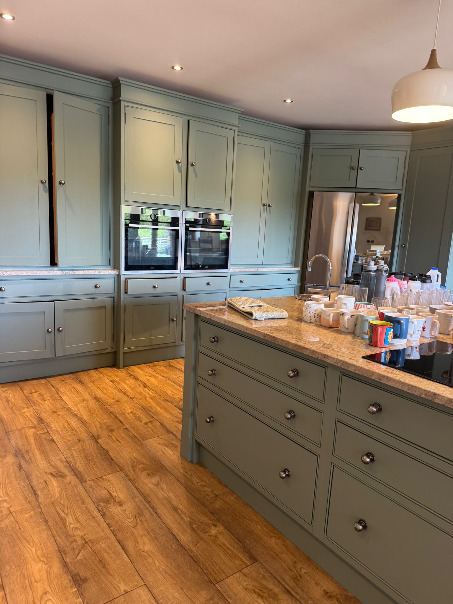 Sage green shaker kitchen with hand-painted cabinetry