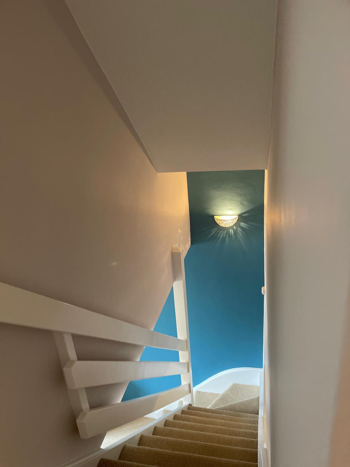 Landing and adjacent spaces with fresh teal and white paintwork