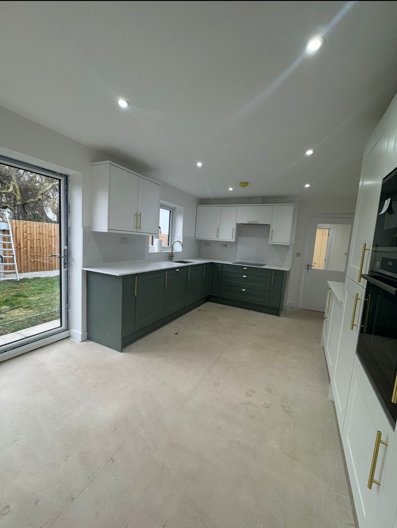 Hand-painted two-tone shaker kitchen with crisp worktops and detailed cabinetry