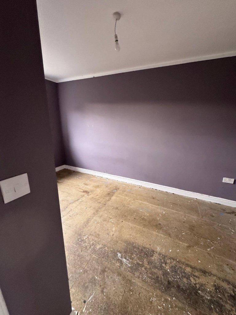 Freshly painted bedroom walls following damp and mould treatment in a void property