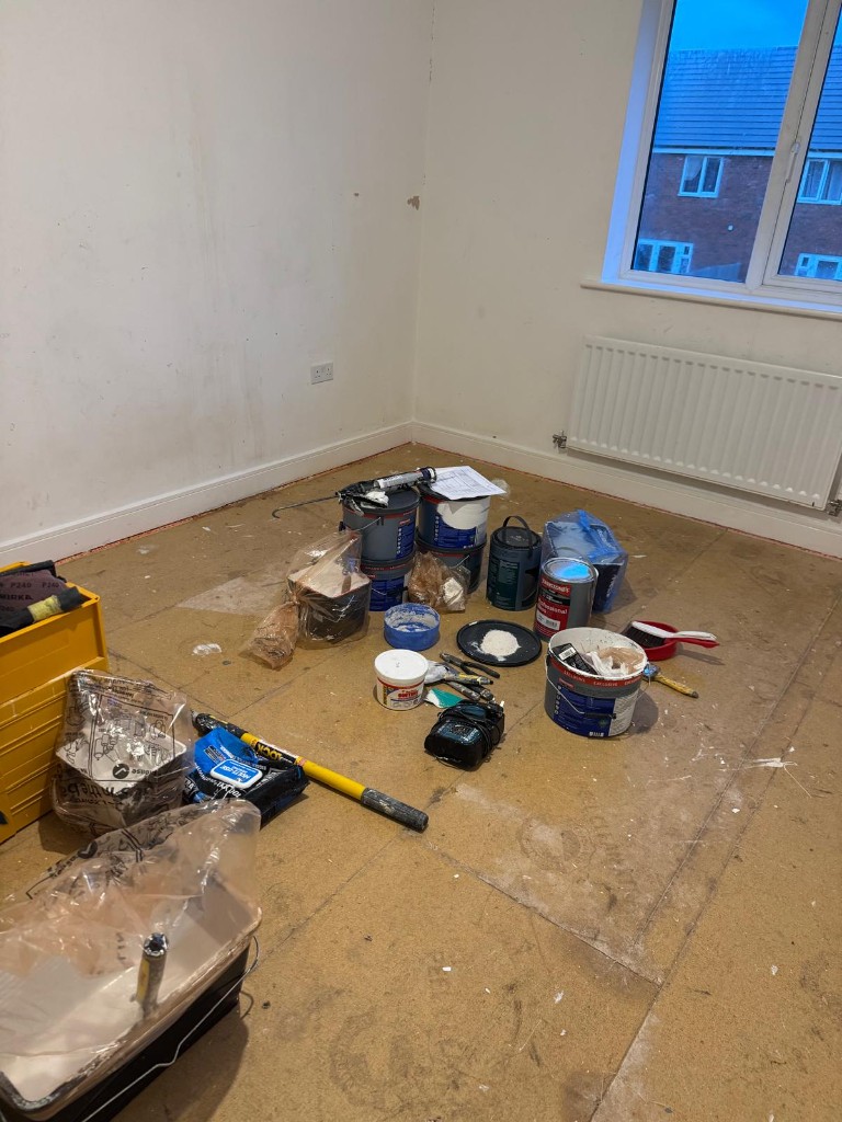 Empty void property with trade paint and decorating equipment ready for redecoration