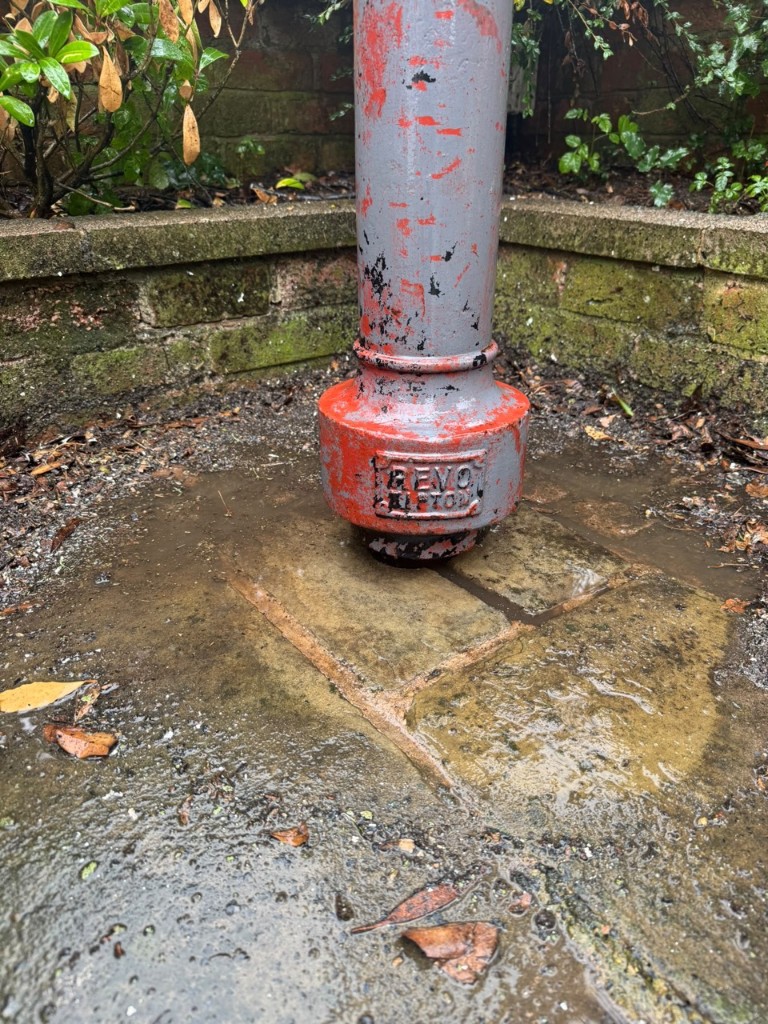 Metal post base and wet paving after jet cleaning